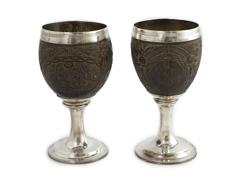 A pair of George III silver mounted coconut cups